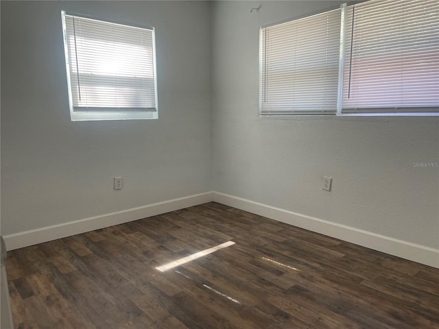 unfurnished room featuring dark wood-type flooring