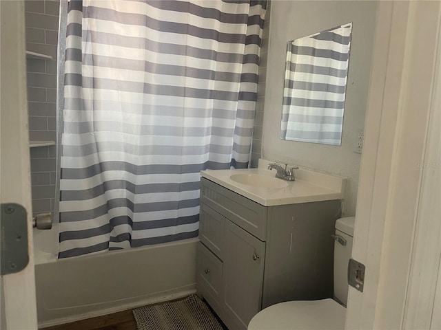 full bathroom featuring shower / bath combination with curtain, vanity, and toilet