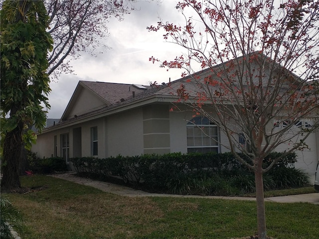 view of property exterior with a yard