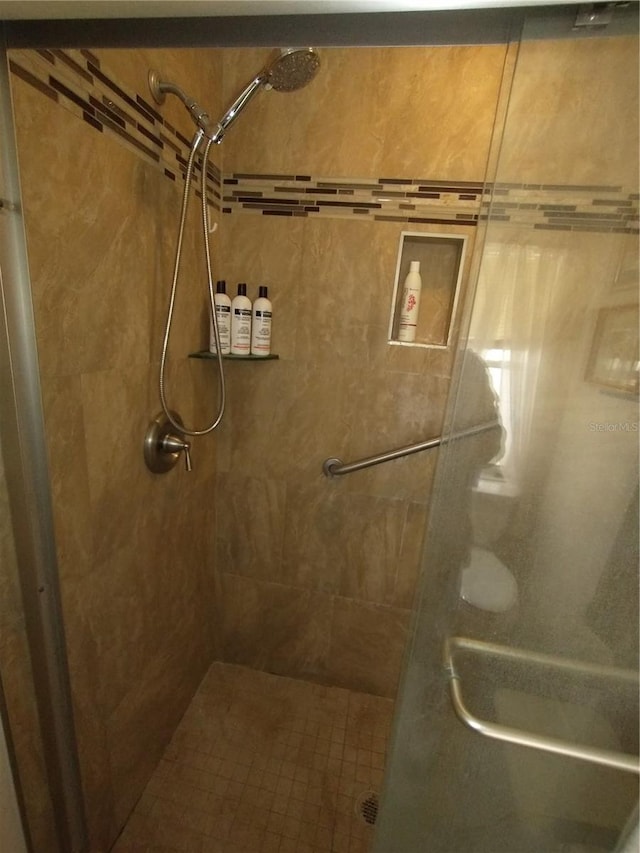 bathroom featuring a shower with shower door