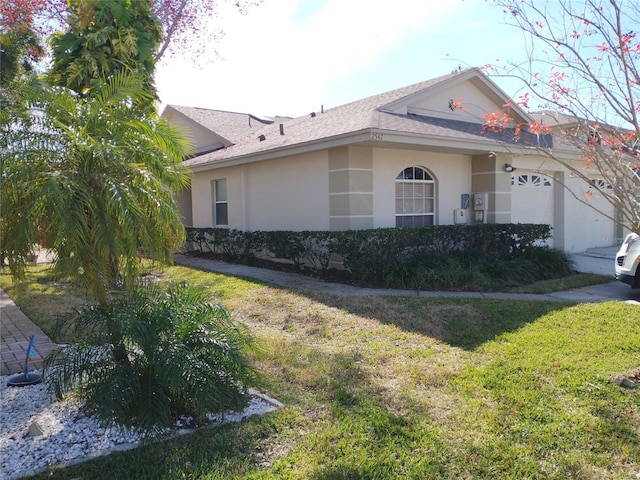 view of property exterior featuring a garage and a lawn