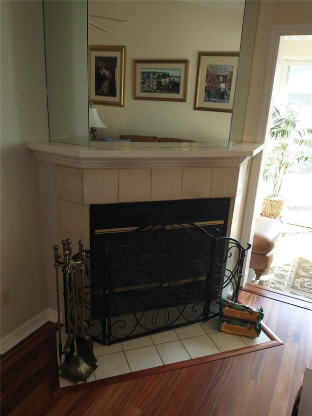 details featuring a tile fireplace and wood-type flooring