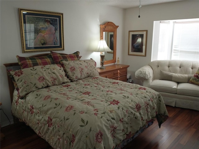 bedroom with dark hardwood / wood-style flooring