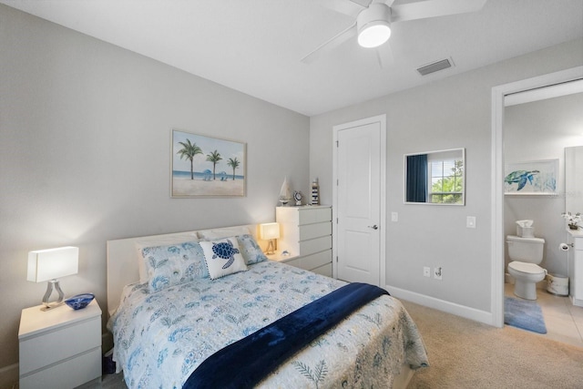 bedroom featuring ceiling fan, ensuite bath, and carpet