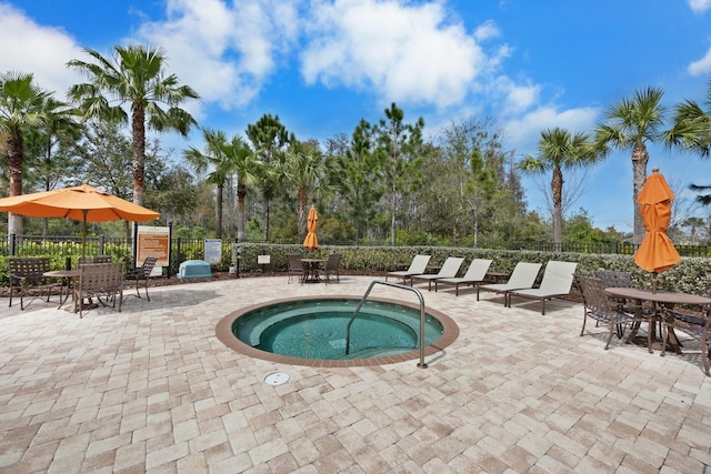 view of pool featuring a community hot tub and a patio