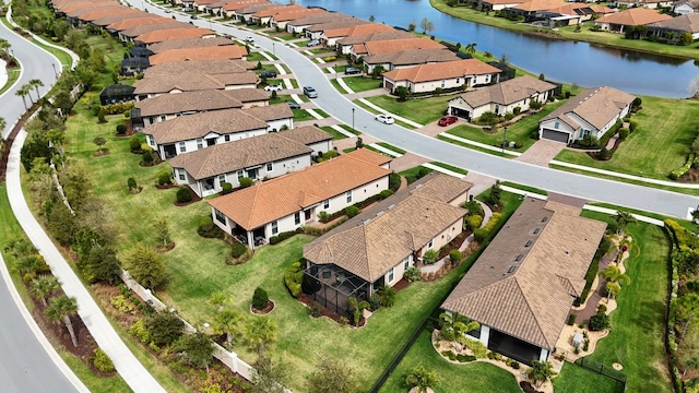 birds eye view of property with a water view