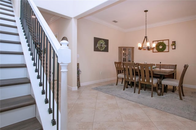 tiled dining area with crown molding and an inviting chandelier