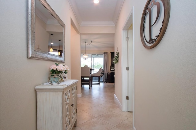 hall featuring ornamental molding and light tile patterned floors