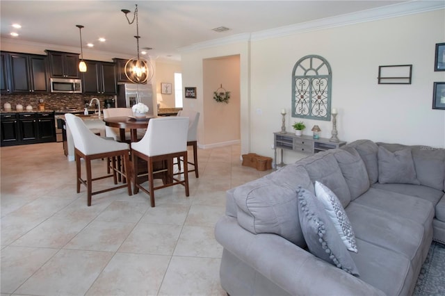 dining area with crown molding and light tile patterned floors