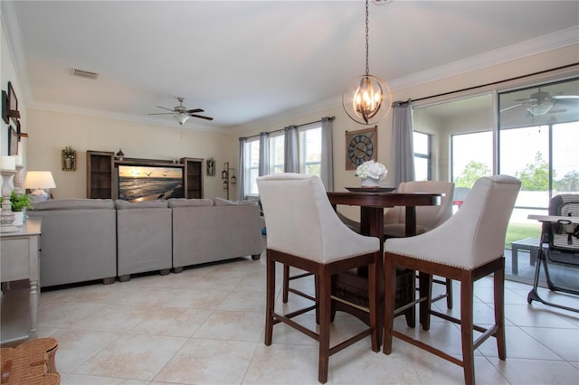 tiled dining room featuring ceiling fan with notable chandelier and ornamental molding