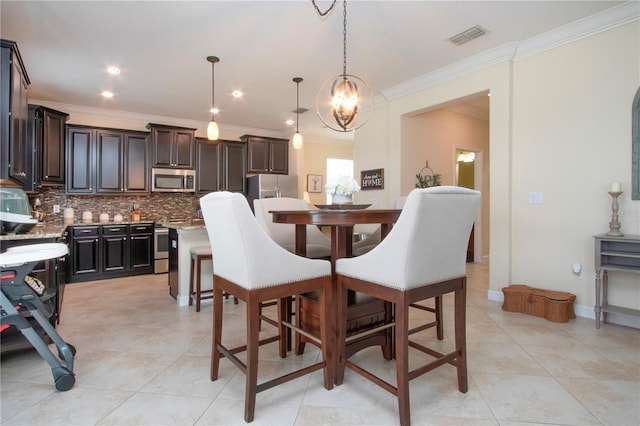 tiled dining room featuring ornamental molding