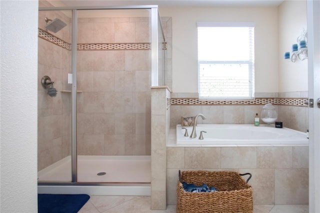 bathroom with tile patterned flooring and separate shower and tub