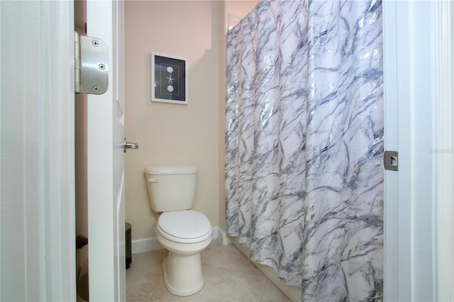 bathroom featuring a shower with curtain, toilet, and tile patterned flooring