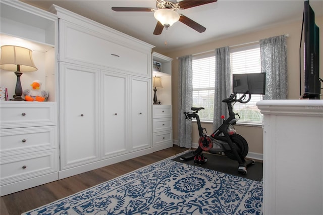 workout area with dark wood-type flooring and ceiling fan