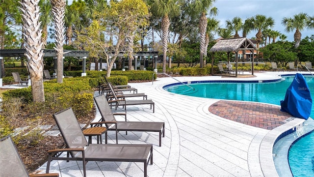 view of pool with a pergola and a patio