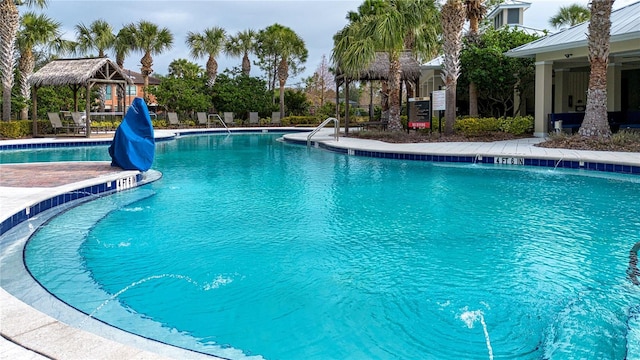 view of pool with a gazebo, pool water feature, and a water slide