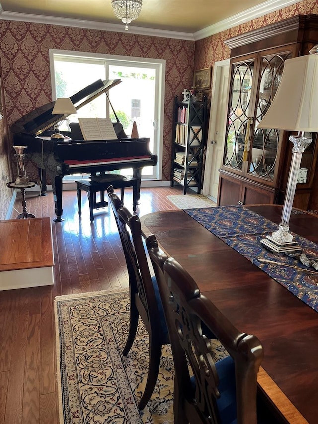 dining area with hardwood / wood-style flooring and ornamental molding