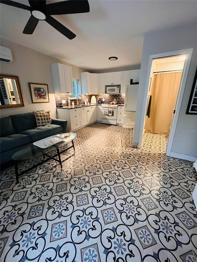 tiled living room featuring sink, a wall unit AC, and ceiling fan