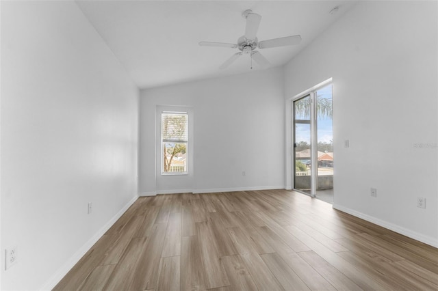 empty room with lofted ceiling, ceiling fan, light hardwood / wood-style floors, and a healthy amount of sunlight