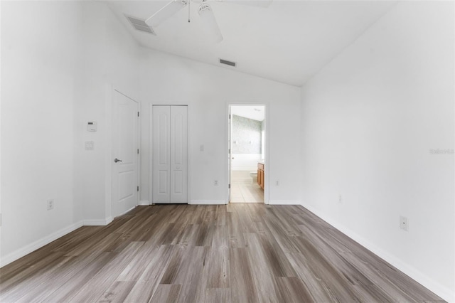 unfurnished room with ceiling fan, lofted ceiling, and light hardwood / wood-style flooring