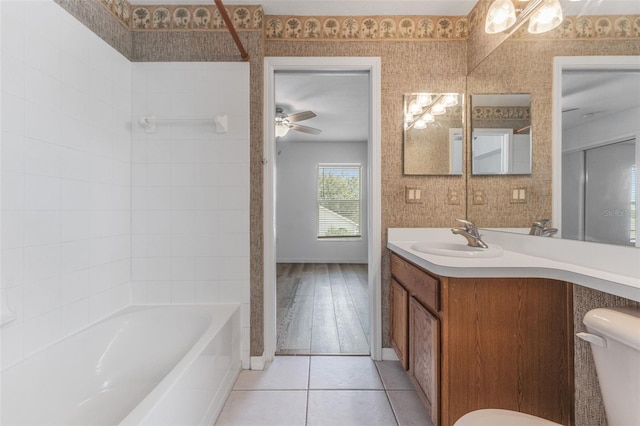 full bathroom with shower / bathtub combination, vanity, ceiling fan, toilet, and tile patterned floors