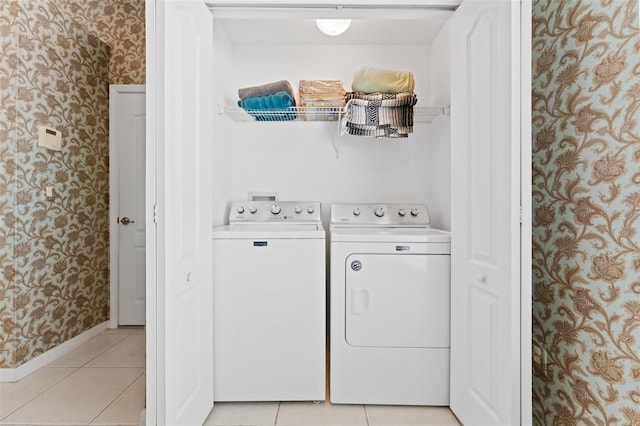 laundry room featuring separate washer and dryer and light tile patterned floors