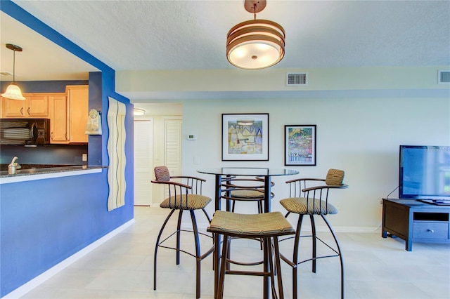 dining area with a textured ceiling