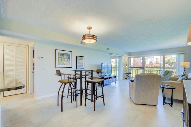 dining space featuring a textured ceiling