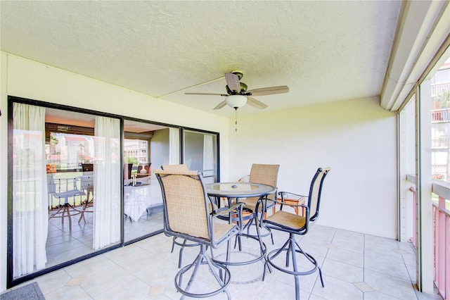 sunroom / solarium featuring plenty of natural light and ceiling fan