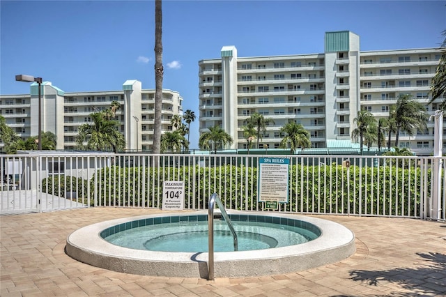 view of swimming pool with a community hot tub