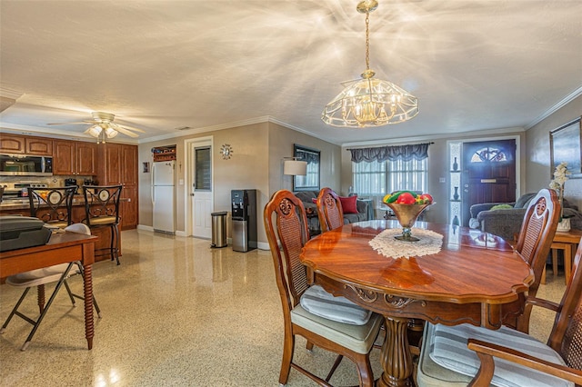 dining area featuring ceiling fan with notable chandelier, ornamental molding, and a textured ceiling