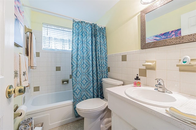 full bathroom with tile walls, shower / tub combo, vanity, and toilet