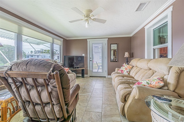 living room featuring ceiling fan, crown molding, and a textured ceiling