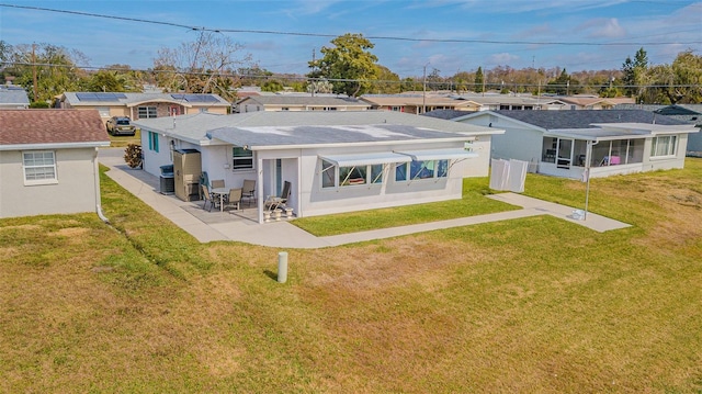 back of house with a yard and a patio area