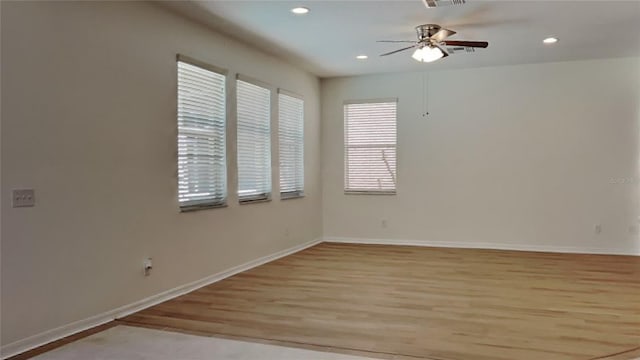 spare room featuring light hardwood / wood-style flooring and ceiling fan