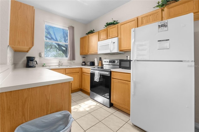 kitchen featuring light brown cabinetry, sink, white appliances, and light tile patterned flooring