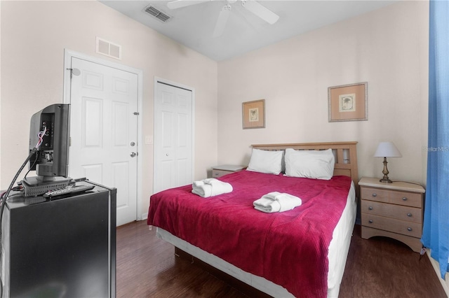 bedroom with ceiling fan and dark hardwood / wood-style floors