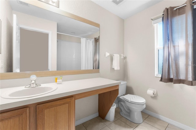 bathroom with tile patterned flooring, vanity, a shower with curtain, and toilet