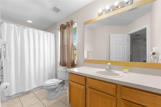 bathroom with vanity, tile patterned floors, and toilet