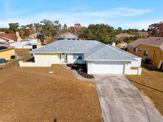 single story home featuring a garage and a front lawn