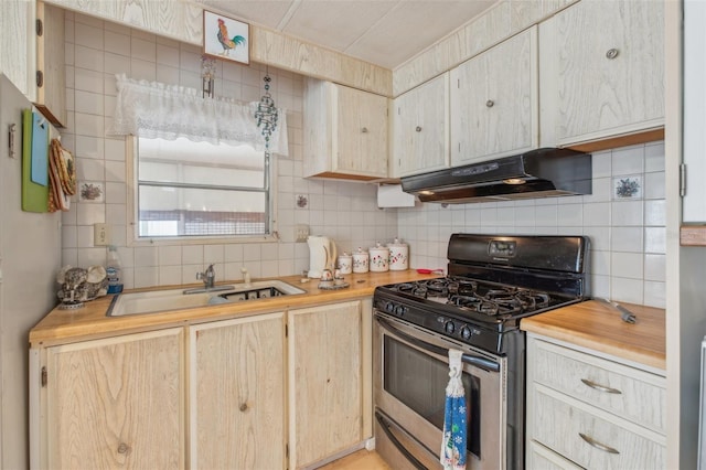 kitchen with tasteful backsplash, extractor fan, gas range, and sink