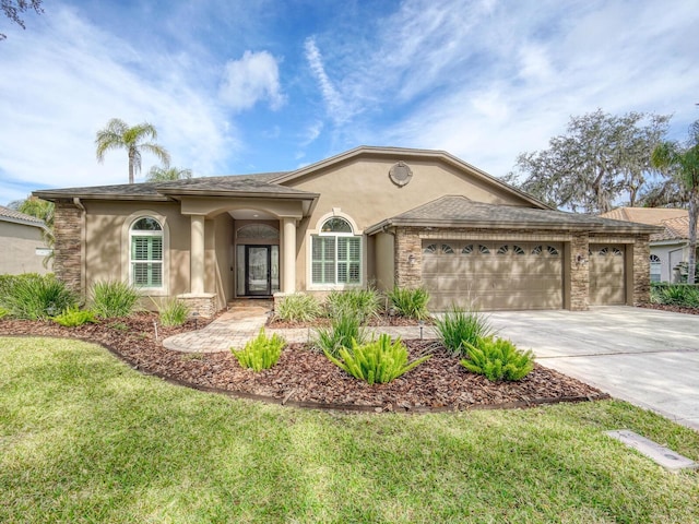 ranch-style home with a garage and a front lawn