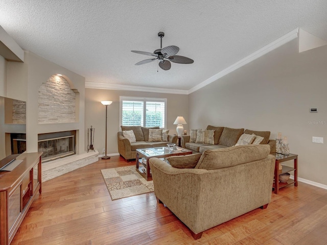 living room with ceiling fan, crown molding, wood-type flooring, and a textured ceiling