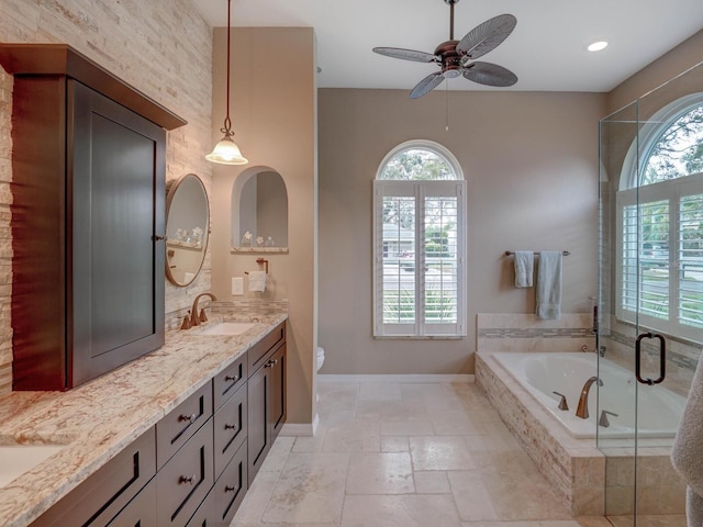 full bathroom with toilet, plenty of natural light, plus walk in shower, and vanity