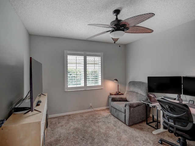 carpeted office space featuring ceiling fan and a textured ceiling