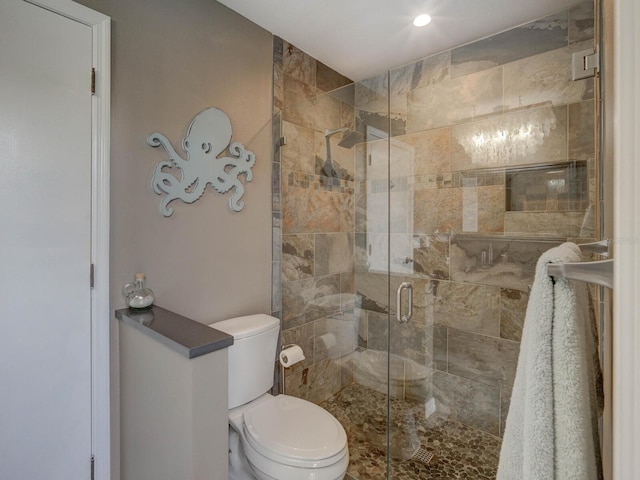 bathroom featuring walk in shower and toilet