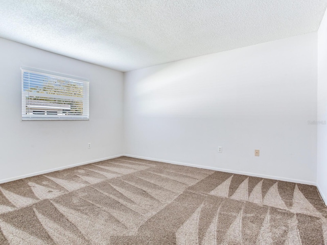 carpeted spare room with a textured ceiling