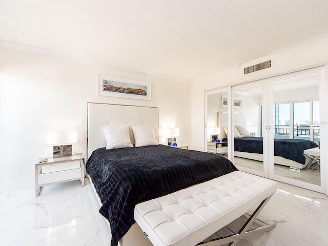 bedroom featuring ornamental molding and french doors