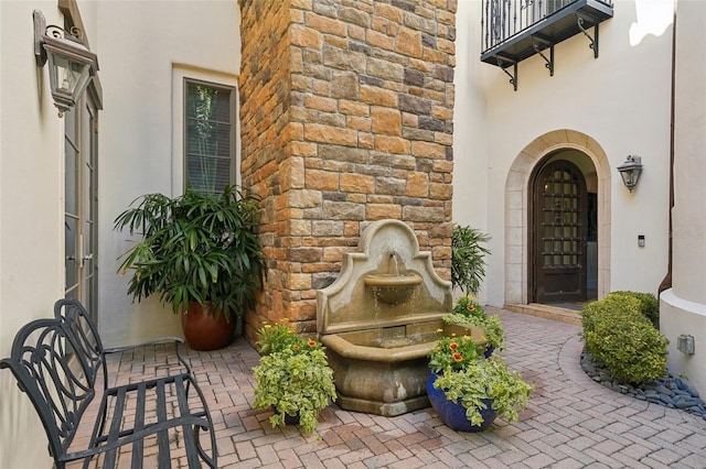 property entrance with stucco siding