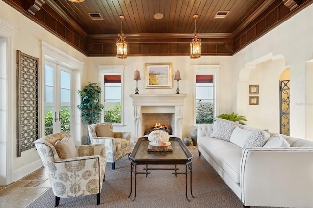 living area with wooden ceiling, a warm lit fireplace, visible vents, and french doors